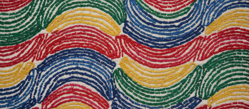 A Kantha quilt stitched with wave-like climate patterns