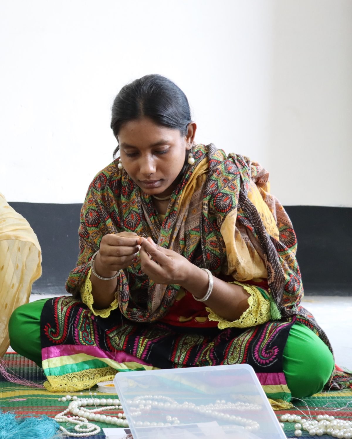 Munni making jewelry