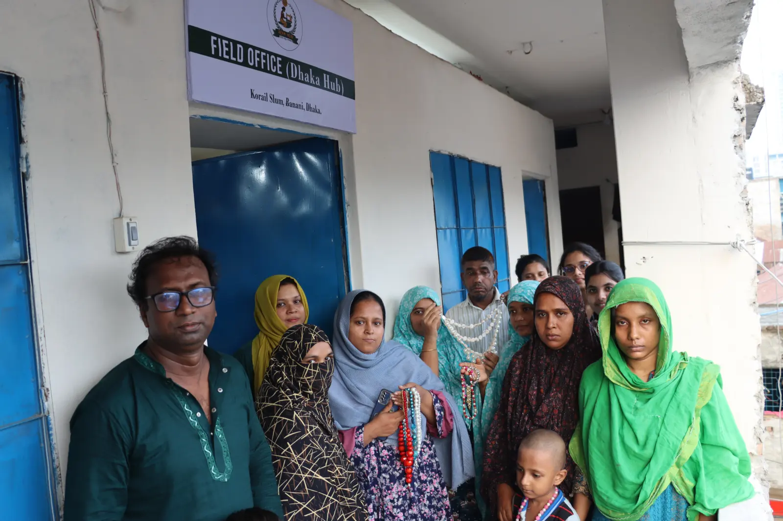 A group of women artisans and staff standing outside the Dhaka hub field office